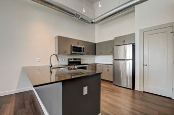 a kitchen with an island and stainless steel appliances